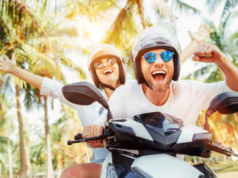 Happy,Smiling,Couple,Travelers,Riding,Motorbike,Scooter,In,Safety,Helmets